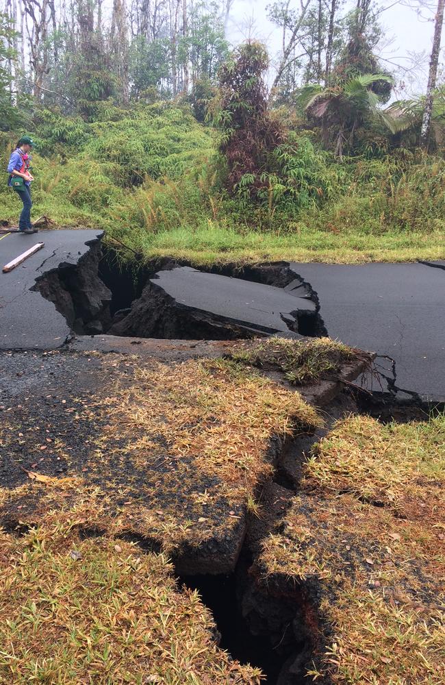 A Hawaiian Volcano Observatory geologist investigates a huge crack in the road in Pahoa, Hawaii. Picture: US Geological Survey via AP