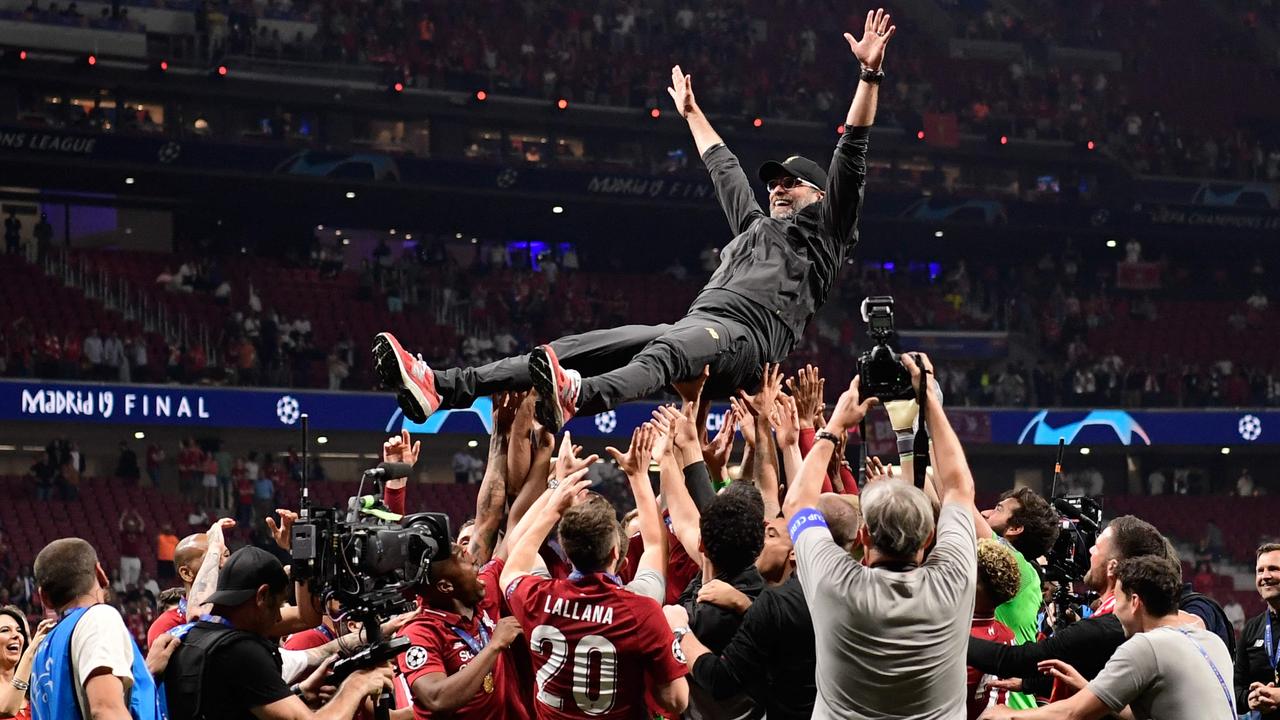 (FILES) Liverpool's players throw German manager Jurgen Klopp (C) in the air after winning the UEFA Champions League final football match between Liverpool and Tottenham Hotspur at the Wanda Metropolitano Stadium in Madrid on June 1, 2019. Jurgen Klopp will manage his last match, at Anfield on May 19, 2024 after announcing in January of the same year, that he would be stepping down at the end of the season. The German coach became the only Liverpool manager to complete the collection of Premier League, Champions League, FA Cup, League Cup, Club World Cup and Community Shield during his nine year tenure. (Photo by JAVIER SORIANO / AFP)