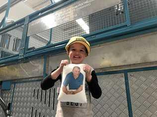 NEW MACHINE: Kyrese Skinner holds up a photo of his grandfather Robert Channing, who had a new composite fibre pultrusion machine unveiled in his honour at the Wagners facility at Wellcamp and (inset) Wagners executive general manager Michael Kemp and Tracey Channing in front of the machine. Picture: Tobi Loftus