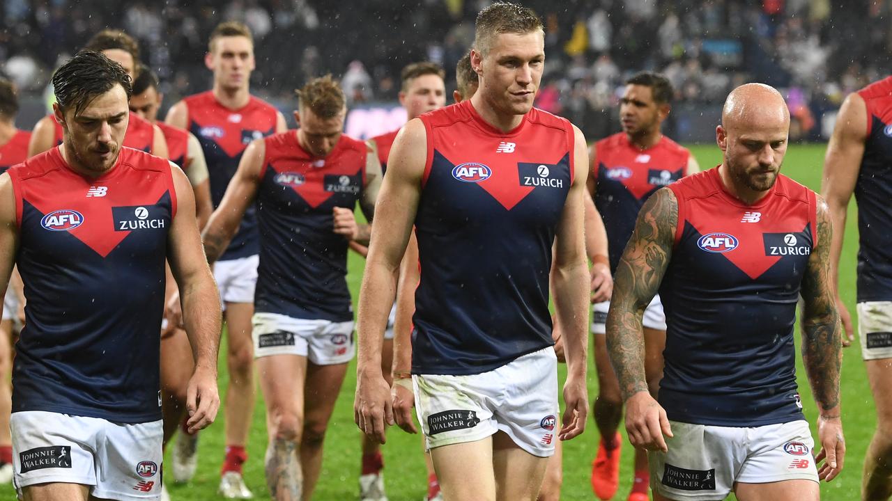 Melbourne players leave the ground after their disappointing loss to Geelong. Picture: AAP Images 