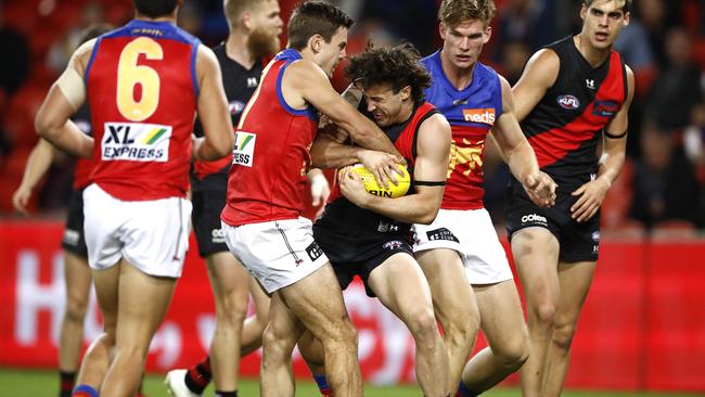 GOLD COAST, AUSTRALIA - JULY 31: Jarrod Berry of the Lions tackles Andrew McGrath of the Bombers during the round nine AFL match between the Essendon Bombers and the Brisbane Lions at Metricon Stadium on July 31, 2020 in Gold Coast, Australia. (Photo by Ryan Pierse/Getty Images)