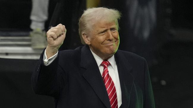 PHILADELPHIA, PENNSYLVANIA - MARCH 22: U.S. President Donald Trump salutes the crowd during the 2025 NCAA Division I Men's Wrestling Championship at the Wells Fargo Center on March 22, 2025 in Philadelphia, Pennsylvania. (Photo by Mitchell Leff/Getty Images)