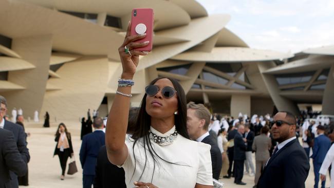 Naomi Campbell takes pictures upon her arrival to the inauguration ceremony of the National Museum of Qatar. Picture: Patrick Baz