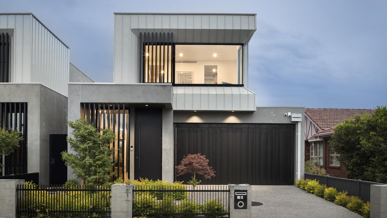 The exterior of the Essendon home features contemporary facade with black vertical slats and glass panels.