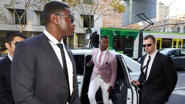 Nelly Yoa arriving at the Melbourne Magistrates Court in Melbourne in June with an entourage. Picture: AAP Image/Erik Anderson