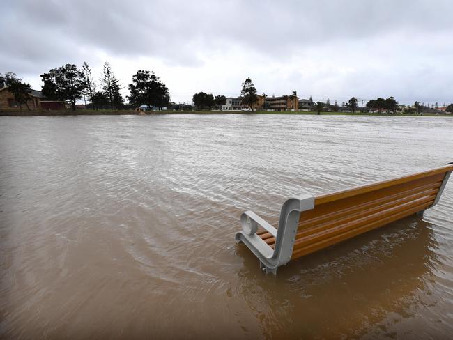 A partially submerged park bench along the Patawalonga in Glenelg North. Picture: Naomi Jellicoe