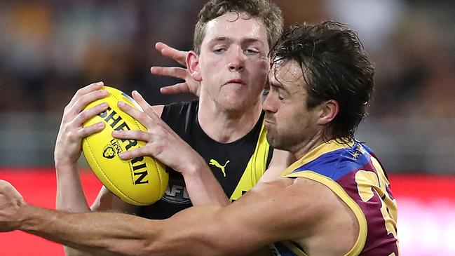 BRISBANE, AUSTRALIA - MAY 21: Riley Collier-Dawkins of the Tigers and Rhys Mathieson of the Lions clash during the round 10 AFL match between the Brisbane Lions and the Richmond Tigers at The Gabba on May 21, 2021 in Brisbane, Australia. (Photo by Jono Searle/AFL Photos/Getty Images)