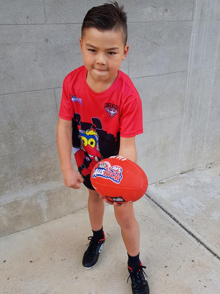 Auskicker Jaguar Bogert, 6, practises a handball. Picture: AFL Photos