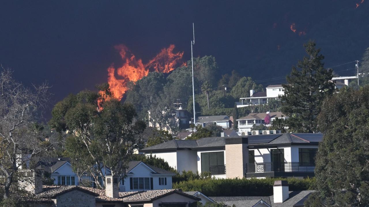 Flames from the Palisades Fire approach homes in Pacific Palisades, California, as seen from Santa Monica, California. Picture: AFP