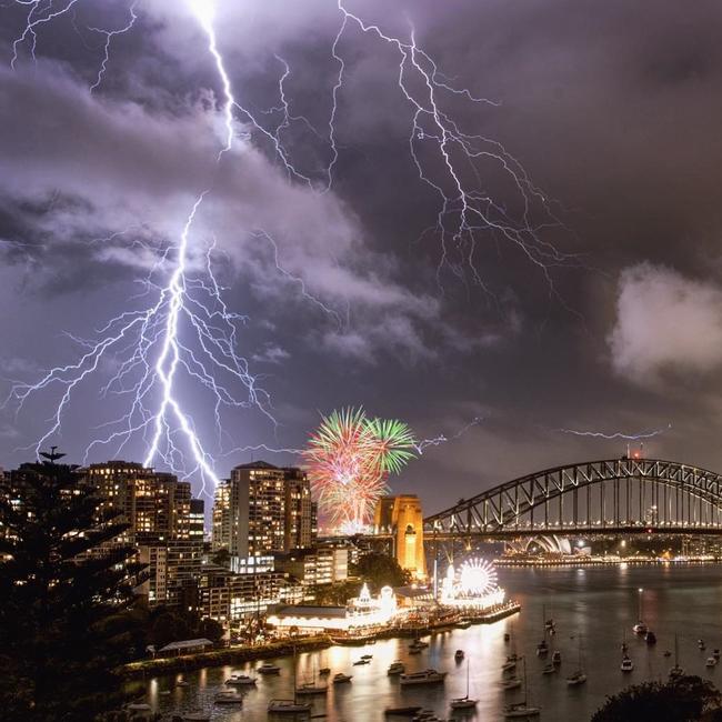 An incredible image of lightning crashing over Sydney Harbour as a fireworks display takes place nearby during a huge storm. Picture: @glanzpunkt