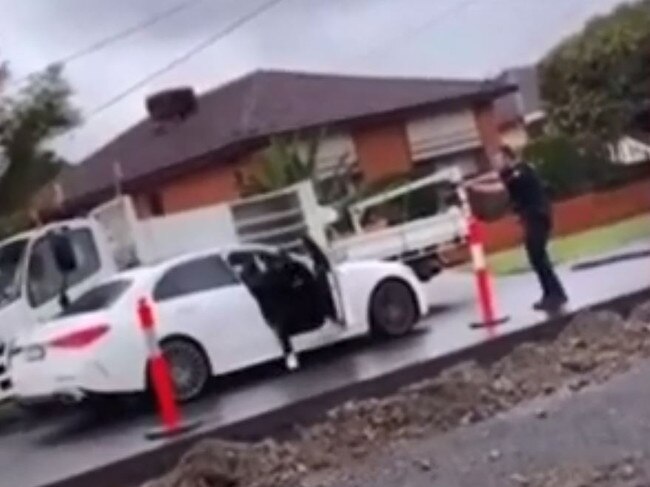 A police officer yells at the driver to ‘get out of the f***ing car’.