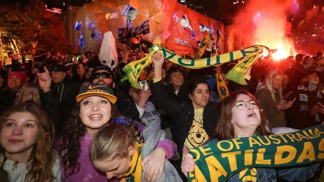 Matildas fans celebrate at Federation Square as Australia win the quarter final in a penalty shootout. Picture: Ian Currie