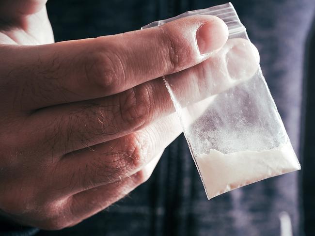 Dealing Drugs By A Man Holding One Little Bag With White Powder In His Hand . Picture: istock