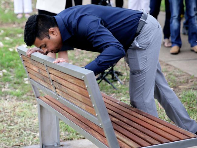 Prabha’s husband Arun Kumar leans down to kiss a plaque unveiled in her memory at Parramatta Park in November.