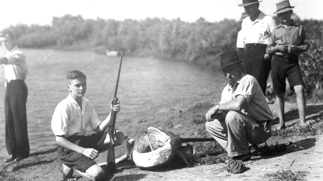 MONSTER CAUGHT: Jim Hamilton, with his rifle, and others with the shark that was hooked after Frank Gurran was mauled in Dump Creek in December 1939.