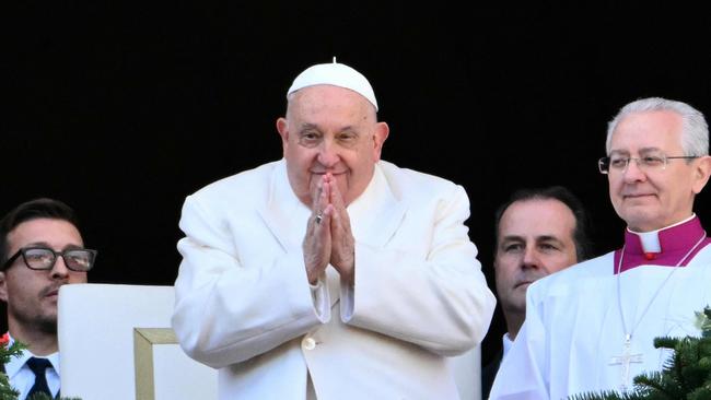 Pope Francis greets the crowd from the main balcony of St. Peter's basilica after the Urbi et Orbi message and blessing to the city and the world. Picture: AFP.