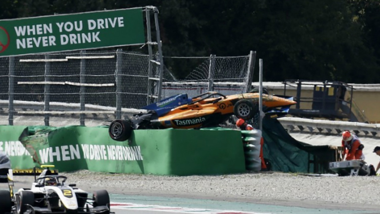 Peroni's car resting on the barriers after the crash.