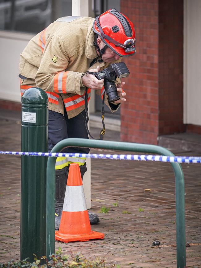 Police and fire investigators at the scene. Picture: AAP/Mike Burton