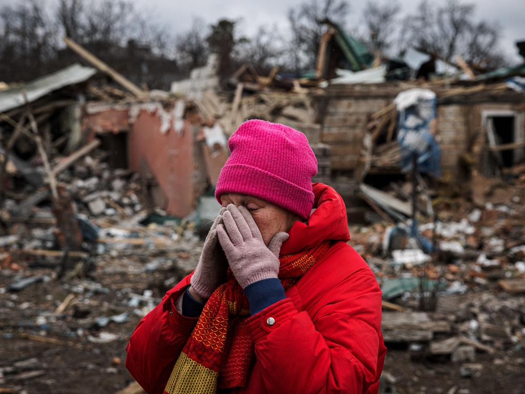 Irina Moprezova, 54, reacts in front of a house that was damaged in an aerial bombing in the city of Irpin, northwest of Kyiv. Picture: AFP