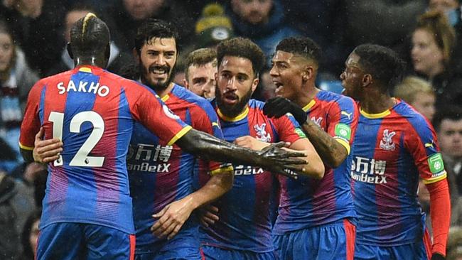 Andros Townsend is mobbed by his teammates after scoring.