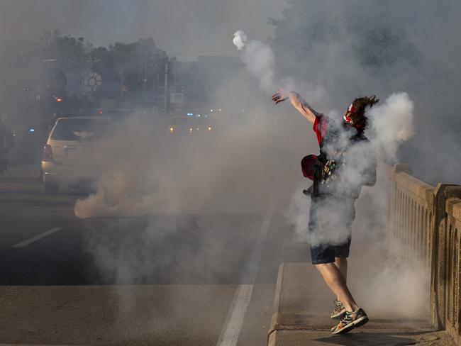 A protester throws a tear gas canister back toward Stafford County deputies on the Falmouth Bridge in Fredericksburg, Virginia. Picture: AP