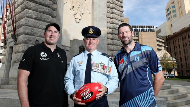 Port coach Matthew Lokan and Sturt coach Marty Mattner at the Adelaide War Memorial with Squadron Leader Peter Nelson who will toss the coin at Wednesday's Anzac Day match. Picture: Dylan Coker