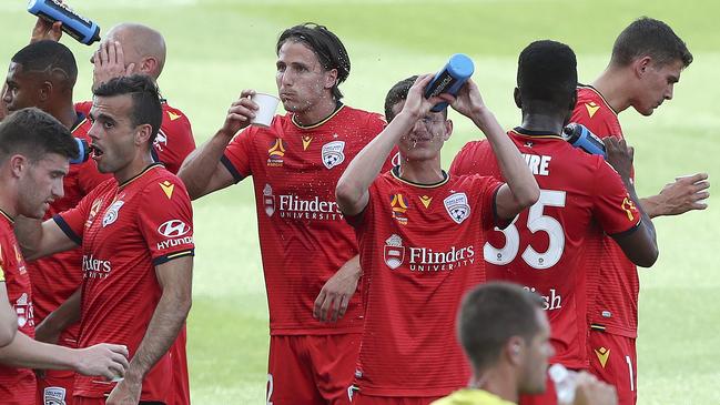 Adelaide United players cool down during one of four drinks breaks in their home win over Newcastle Jets. Picture: Sarah Reed