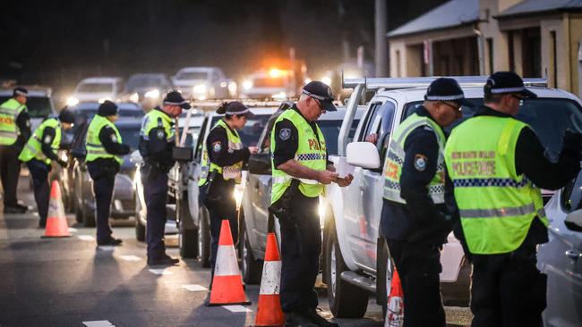 Police stop and question drivers at a checkpoint in Albury. Picture: Getty