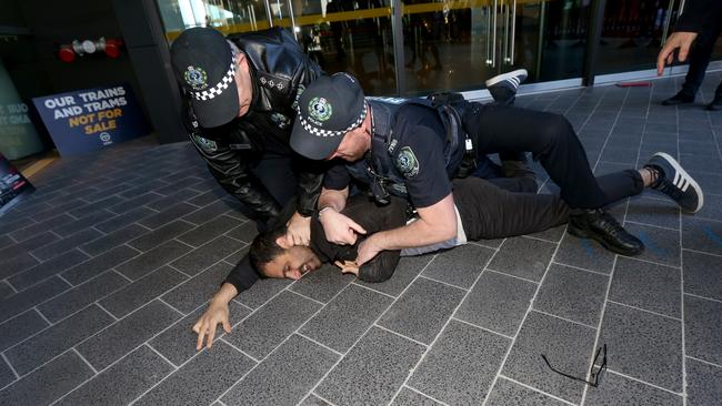 Officers arrest the protester. Picture: Kelly Barnes/AAP