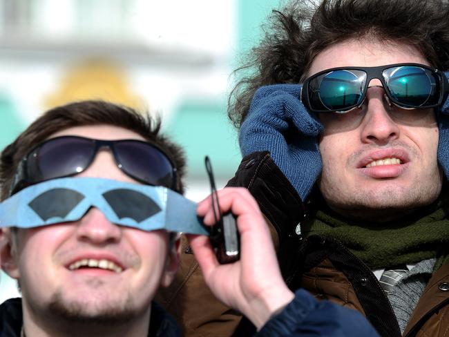 Men watch from St Petersburg. Picture: AFP PHOTO / OLGA MALTSEVA