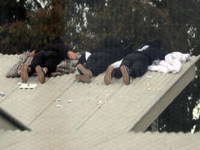 Inmates from the Frank Baxter Juvenile corrections centre Kariong taunt police from the roofs of various buildings. Some are armed with poles tennis rackets ect. Picture: John Grainger