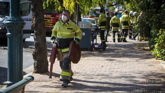 Firefighters outside the Comfort Hotel Meridien in Melbourne Street, North Adelaide, after the fire. Picture: Emma Brasier