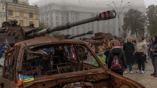 People look at destroyed Russian military vehicles on display in front of Saint Michael's Golden-Domed Monastery in Kyiv.