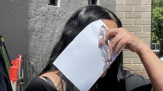 Yusra Mustapha tries to dodge photographs outside court. Picture: Ashleigh Tullis