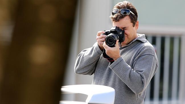 Police photograph cars and family and friends at the funeral for murdered bikie associate Max Waller at Integrity Funerals Parkw