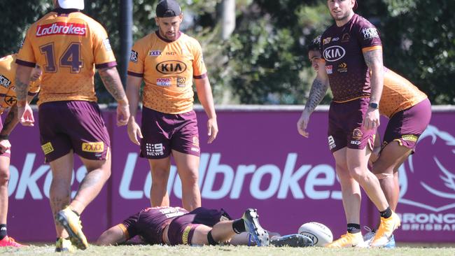 Broncos players look on after Xavier Coates when down with an injured leg. Picture: Peter Wallis