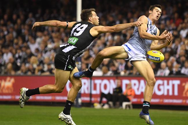 Power’s Connor Rozee (right) and Magpies Levi Greenwood battle for the football at Marvel Stadium in Melbourne. Picture: Julian Smith/AAP