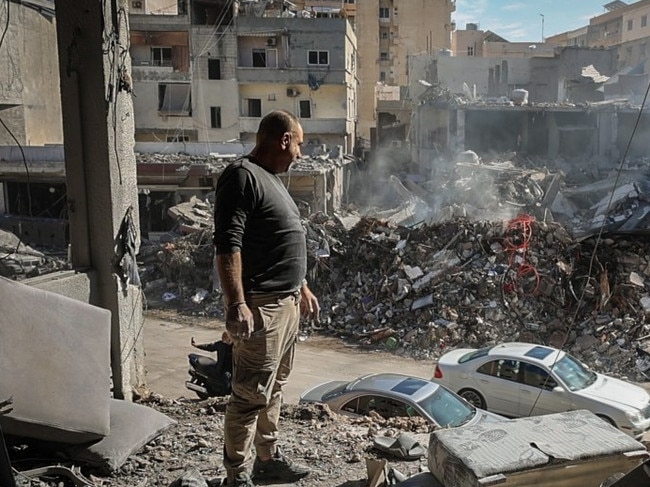 Returning residents take in the apartments destroyed by airstrikes in Tyre. Picture: OLIVER MARSDEN FOR THE TIMES