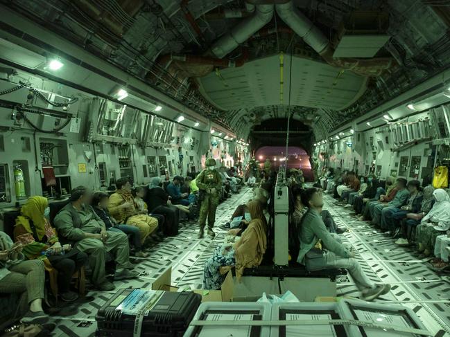 This handout photo taken on August 20 and received August 22, 2021 from the Australian Defence Force shows people onboard the Royal Australian Air Force C-17A Globemaster at Hamid Karzai International Airport in Kabul. (Photo by SGT Glen McCarthy / Australian Defence Force / AFP) / RESTRICTED TO EDITORIAL USE - MANDATORY CREDIT "AFP PHOTO / AUSTRALIAN DEFENCE FORCE" - NO MARKETING - NO ADVERTISING CAMPAIGNS - DISTRIBUTED AS A SERVICE TO CLIENTS