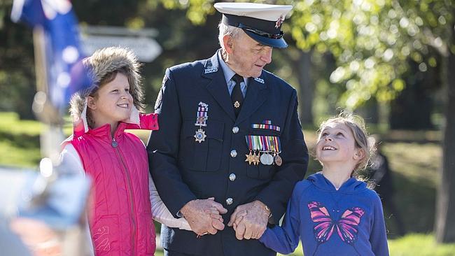 Alana Jones and Keira Jones with their great-grandfather Ernie Baddeley, who enlisted in the merchant navy during WWII at age 16. Picture: Eugene Hylandd