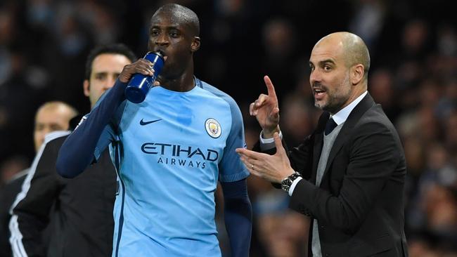 Pep Guardiola in discussion with Yaya Toure of Manchester City.