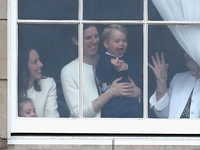 Prince George is held by his nanny Maria Teresa Turrion Borrallo as he waves from the window of Buckingham Palace in 2015. Picture: Chris Jackson/Getty Images