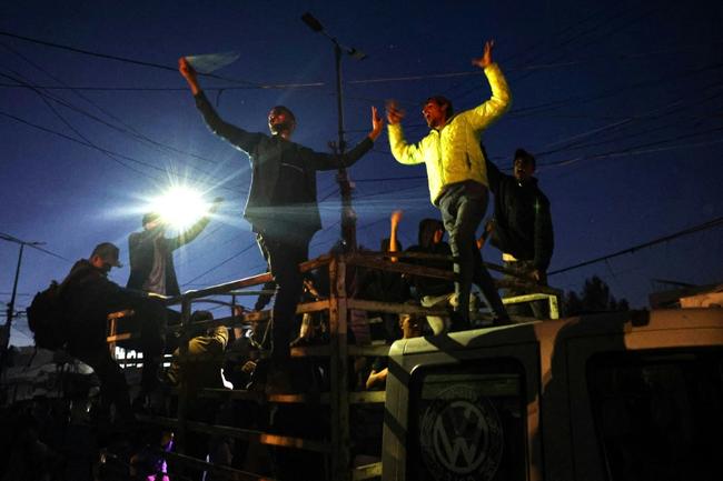 Palestinians celebrate in Rafah, in the southern Gaza Strip, after Hamas announced it accepted a truce proposal