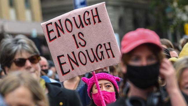 A woman holding a placard during a protest against sexual violence and gender inequality in Melbourne. Picture: AFP