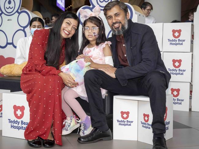 This year’s face of the Good Friday Appeal, Aru, with her parents in the Bear Hospital. Picture: Wayne Taylor