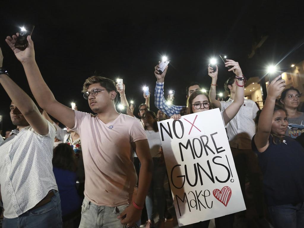 People gather in Juarez, Mexico, Saturday in a vigil for the 3 Mexican nationals who were killed in an El Paso shopping-complex shooting.