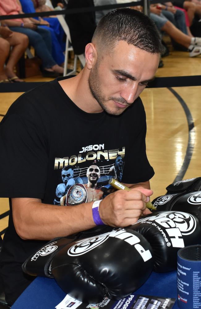 WBO bantamweight world champion Jason Moloney signs some gloves at the Reef 'n' Beef Fight Night, Bravus Arena, Rockhampton, on October 21, 2023.