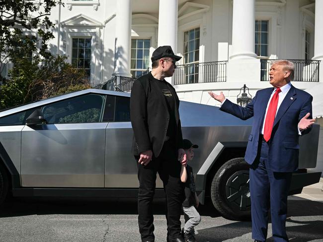 (FILES) US President Donald Trump and Tesla CEO Elon Musk speak to the press as they stand next to a Tesla Cybertruck on the South Portico of the White House on March 11, 2025 in Washington, DC. During his time as US President Donald Trump's controversial cost-cutting billionaire adviser, Elon Musk grabbed nearly as much media attention as the US president. With Musk's Tesla car company taking a battering on the stock market and sales dropping sharply, and with vandalism attacks targeting his brand, Musk marshalled Trump behind the wheel of a Model S and in front of a Cybertruck to defend the brand, turning the White House into a Tesla showroom. (Photo by Mandel NGAN / AFP)
