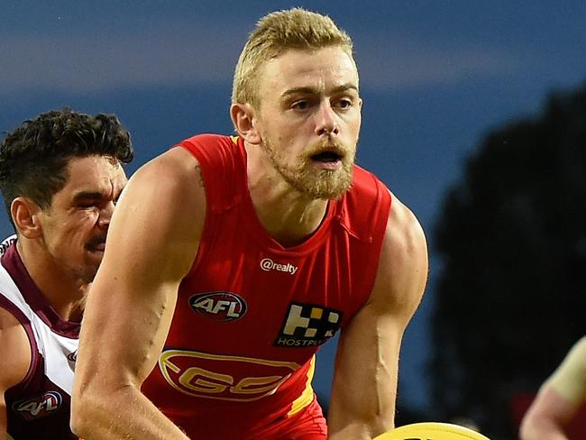 GOLD COAST, AUSTRALIA - MARCH 08: Hugh Greenwood of the Suns handballs during the AFL Community Series match between the Gold Coast Suns and the Brisbane Lions at Metricon Stadium on March 08, 2021 in Gold Coast, Australia. (Photo by Matt Roberts/AFL Photos/via Getty Images)