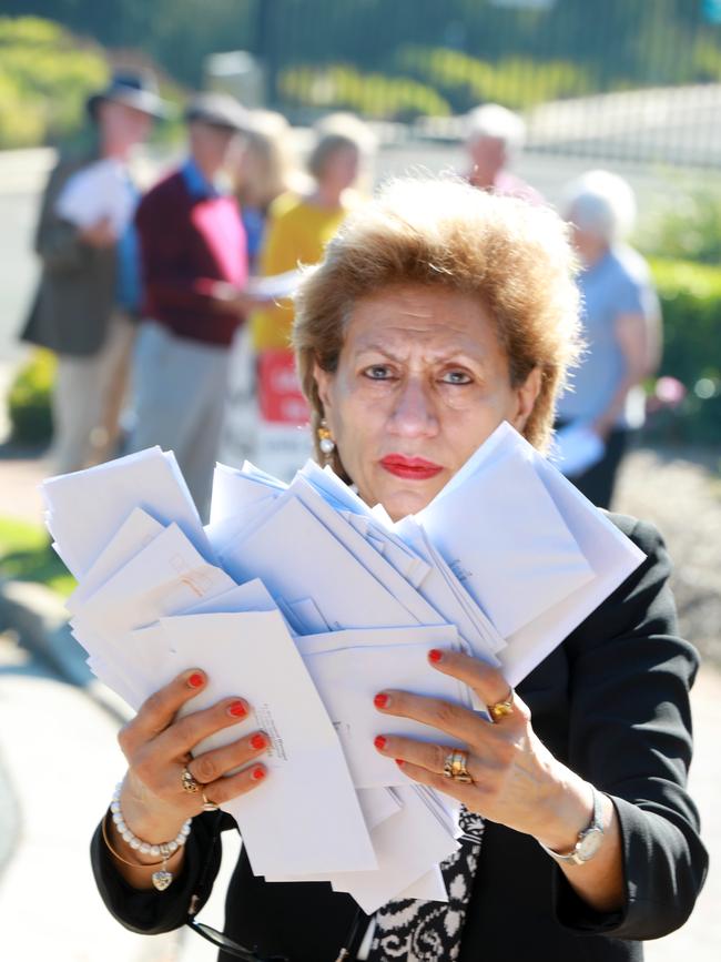 Farida Irani from the Forest in Danger group holds a sample of 3000 objection letters ready to be submitted to Hills Shire Council in Baulkham Hills. (AAP IMAGE / Angelo Velardo)